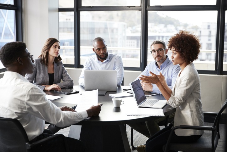 millennial-black-businesswoman-addressing-colleagues-at-a-corporate-business-meeting