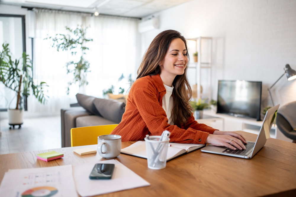 Young smiling businesswoman working from home