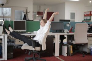 office worker relaxing with feet on table