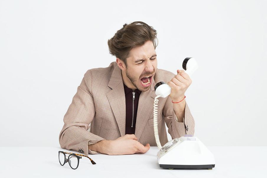 a person speaking into the phone angrily