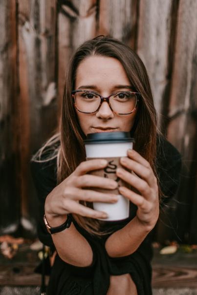 A Picture of a Woman Holding a Cup of Coffee.