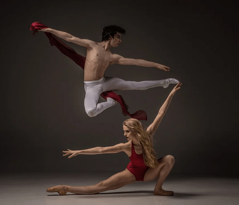 A man and a woman ballet dancers performing a stunt