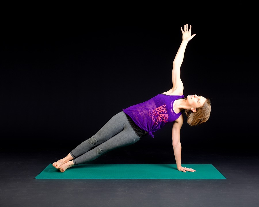 a woman in a green yoga mat, exercising