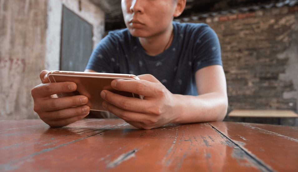 a person playing a game on his mobile phone
