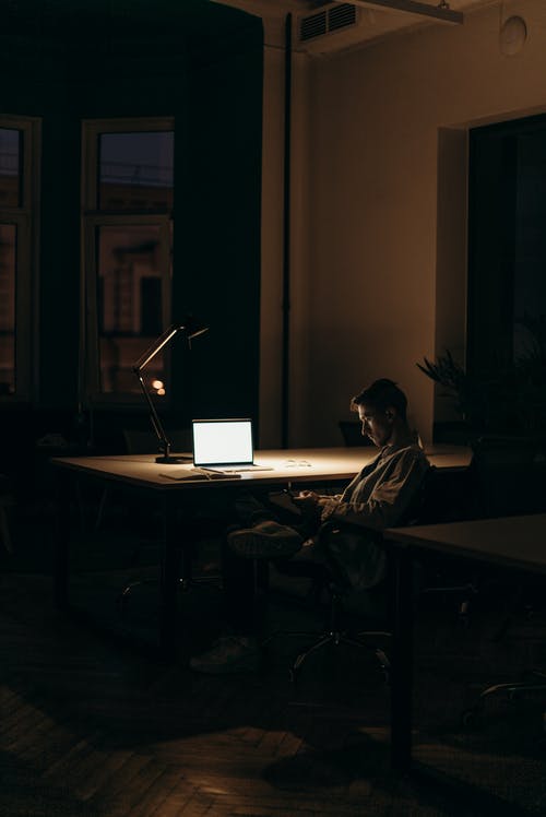 Man sitting alone in a home on his workstation