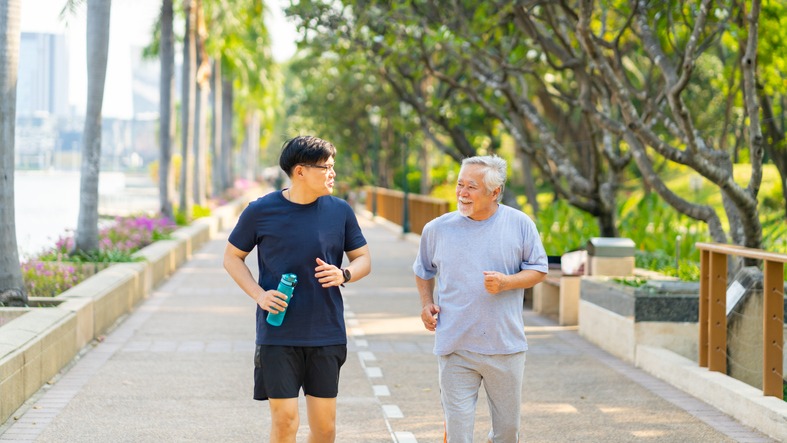 asian-adult-son-and-elderly-father-jogging-exercise-together-at-park