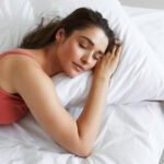 top-view-of-beautiful-young-woman-sleeping-while-lying-in-bed