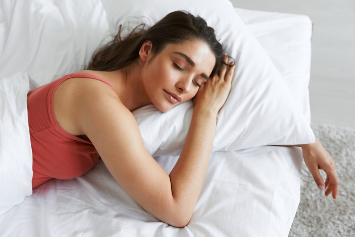 top-view-of-beautiful-young-woman-sleeping-while-lying-in-bed